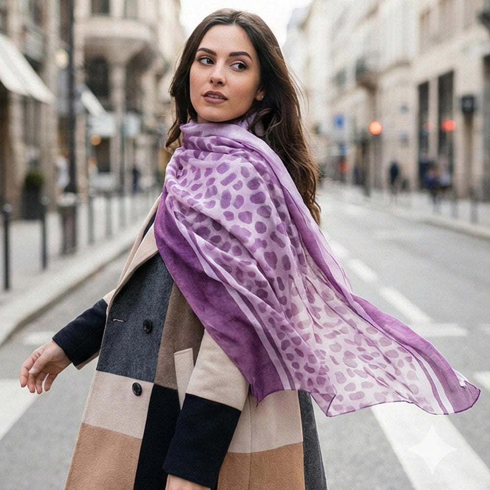 Purple cheetah print scarf draped on a woman walking in the city