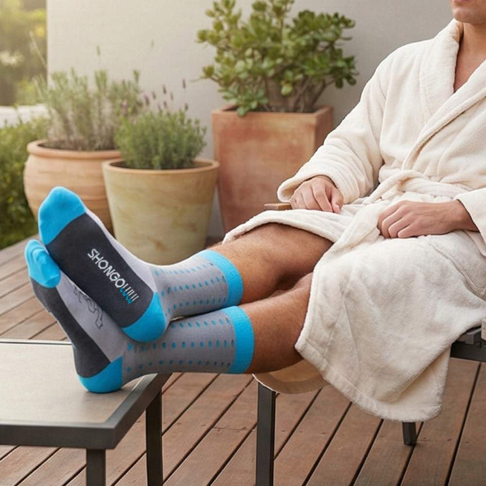 Person wearing gray and blue socks with 'Shongolulu' branding, sitting outdoors in a bathrobe.