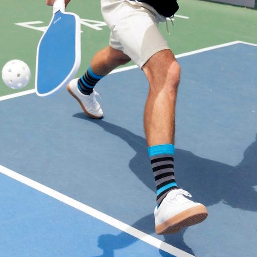Rhino Black Grey & Blue Striped Tall Socks worn by male pickleball player playing pickleball
