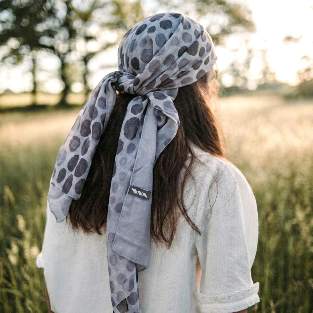 Shongolulu leopard print scarf worn around woman's head