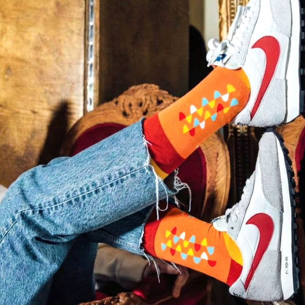 girl wearing Lion print socks in orange red and yellow