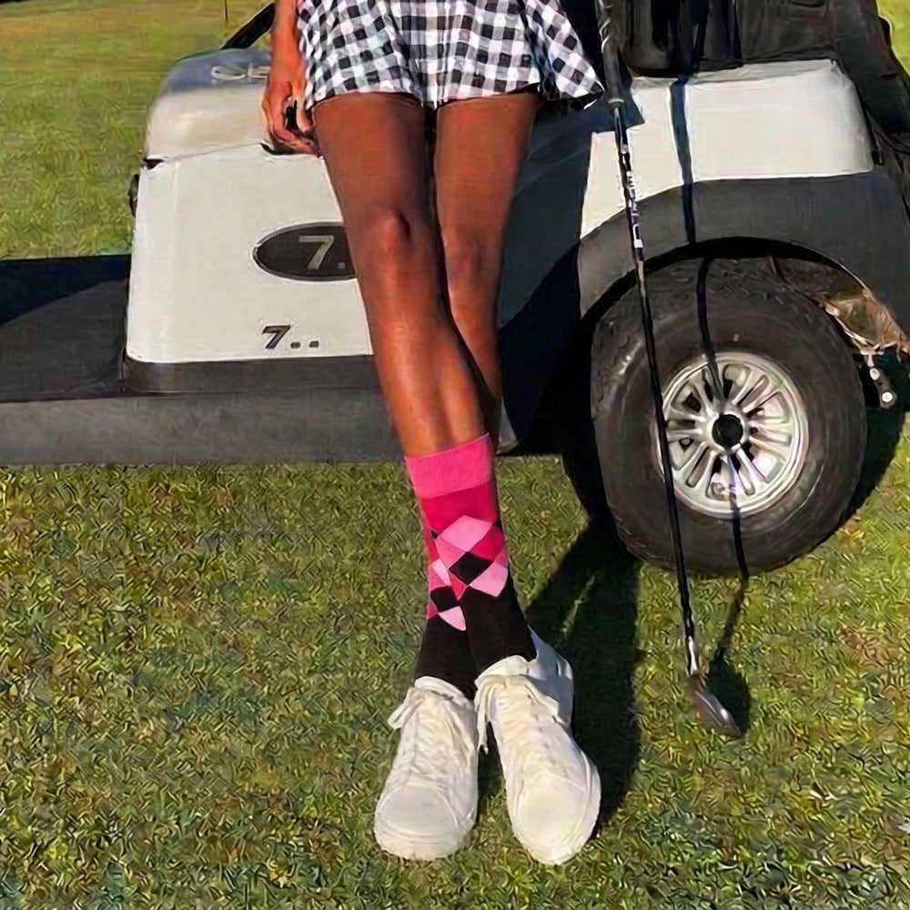 Rhino Print Pink & Black Argyle Crew Socks shown worn by female golfer at the golf course