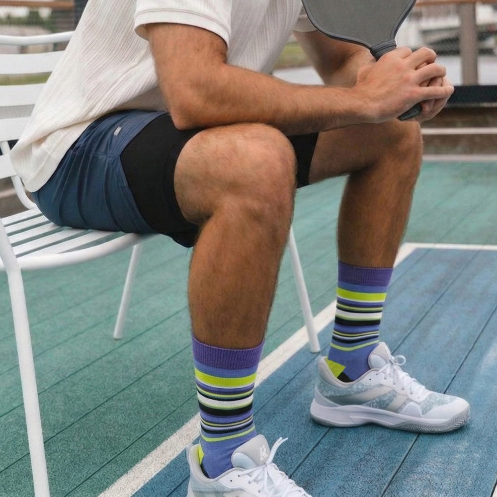 Rhino Print Purple, Neon Green, White & Black Stripe Tall Socks worn by male pickleball player