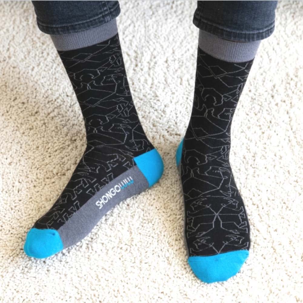 man wearing Shongolulu grey rhino print socks with jeans
