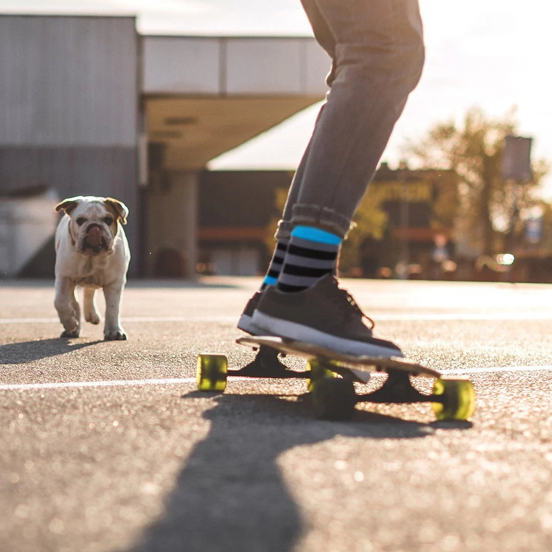 kid riding a skateboard while wearing striped Shongolulu socks