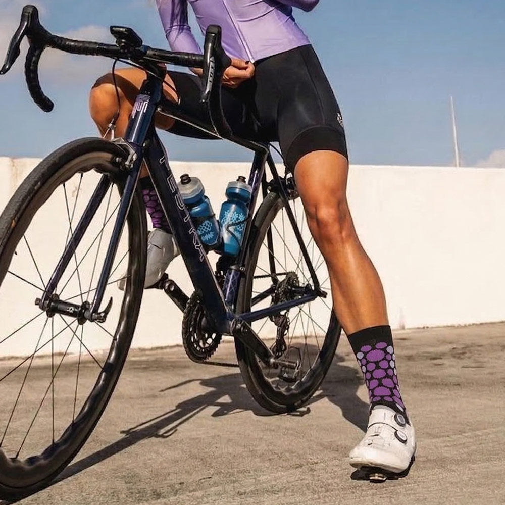 purple cheetah print sock worn by cyclist
