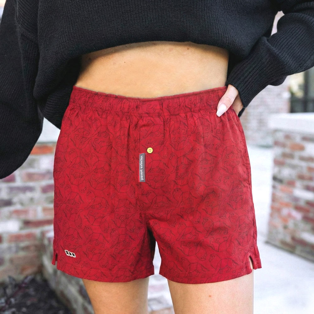 Red lion print boxer shorts worn by a woman unisex style