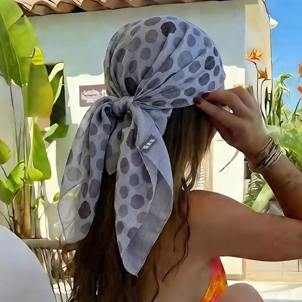 Shongolulu leopard print scarf worn around woman's head