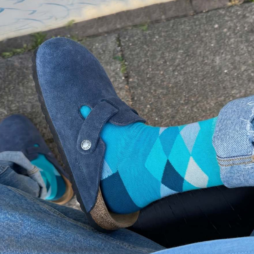 Blue argyle elephant print socks worn with Birkenstock sandals