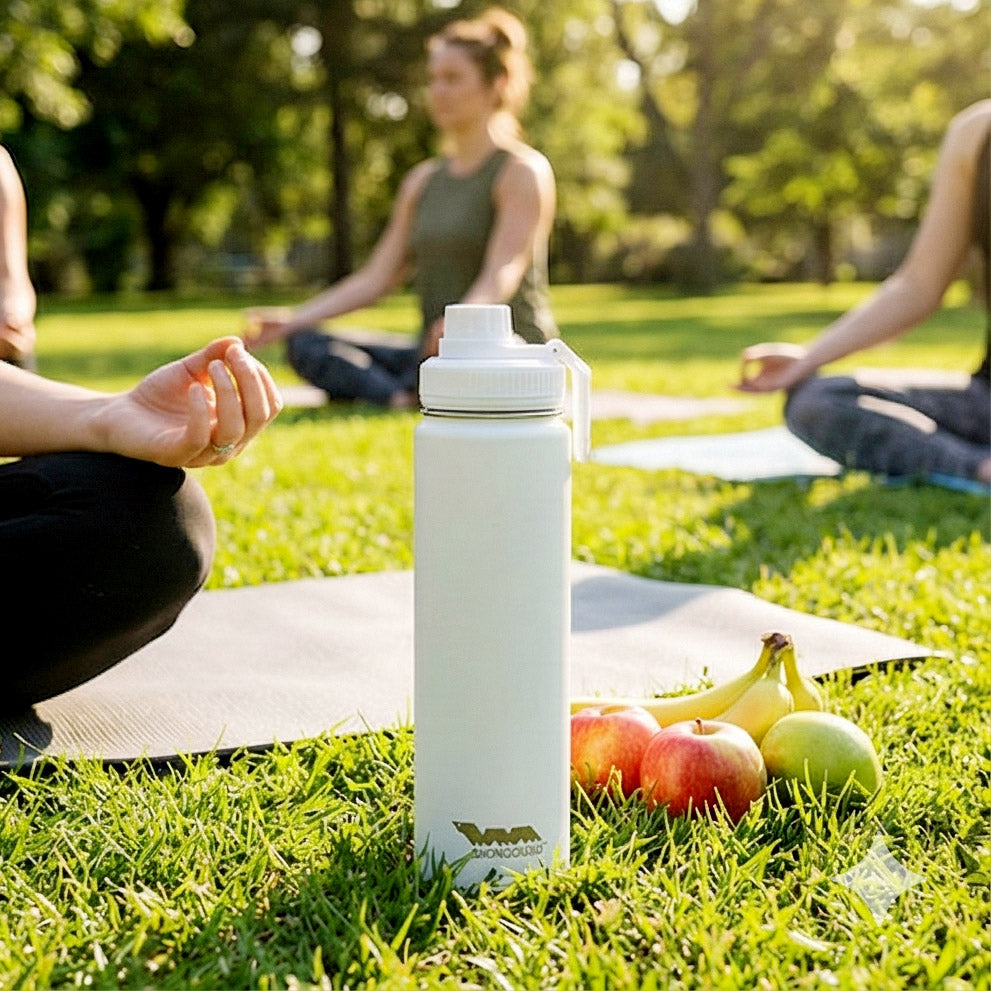 White Shongolulu water bottle on grass with people meditating in the background